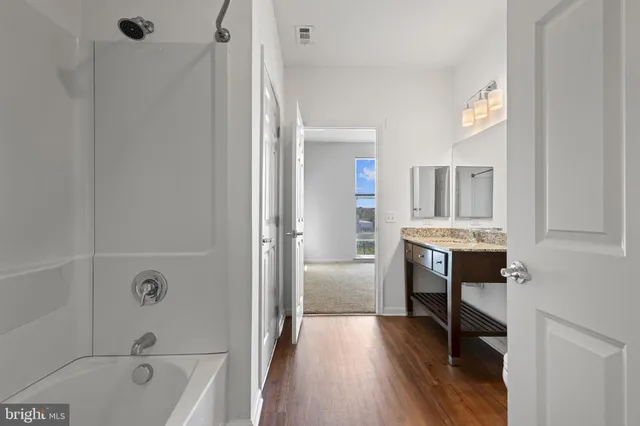 a bathroom with a bathtub shower sink and toilet