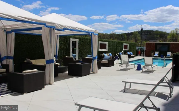 a view of a patio with couches table and chairs and potted plants