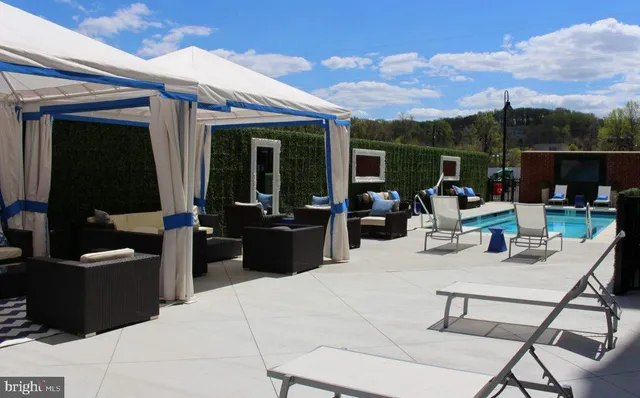 a view of a patio with couches table and chairs and potted plants