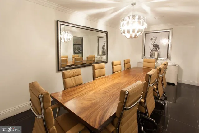 a dining room with furniture a chandelier and wooden floor
