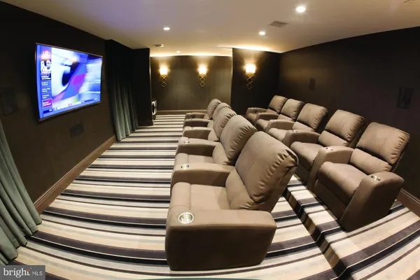 a media room with lots of chairs and a projector screen