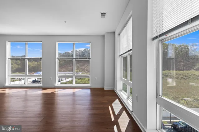 a view of an entryway with wooden floor and windows
