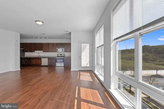 a view of a kitchen with a sink and cabinets