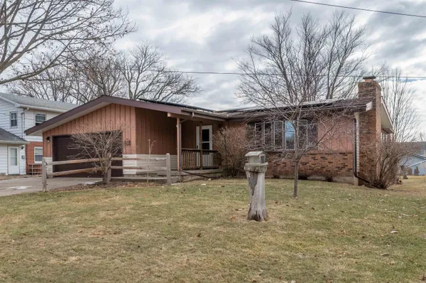a view of a house with a yard and garage