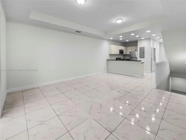 a view of kitchen with granite countertop cabinets and white appliances