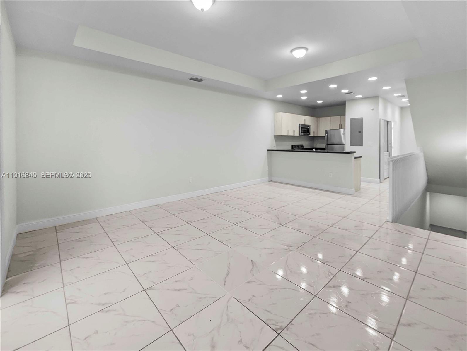 a view of kitchen with granite countertop cabinets and white appliances
