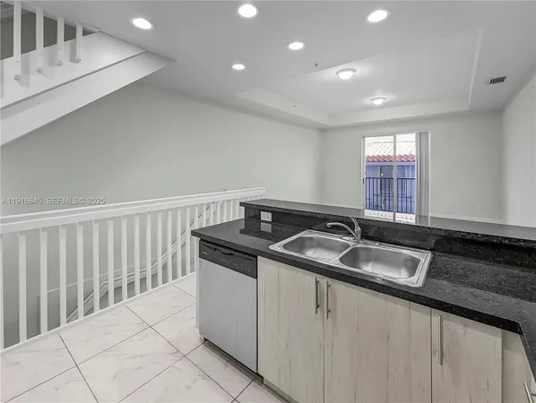 a kitchen with granite countertop a stove and a microwave