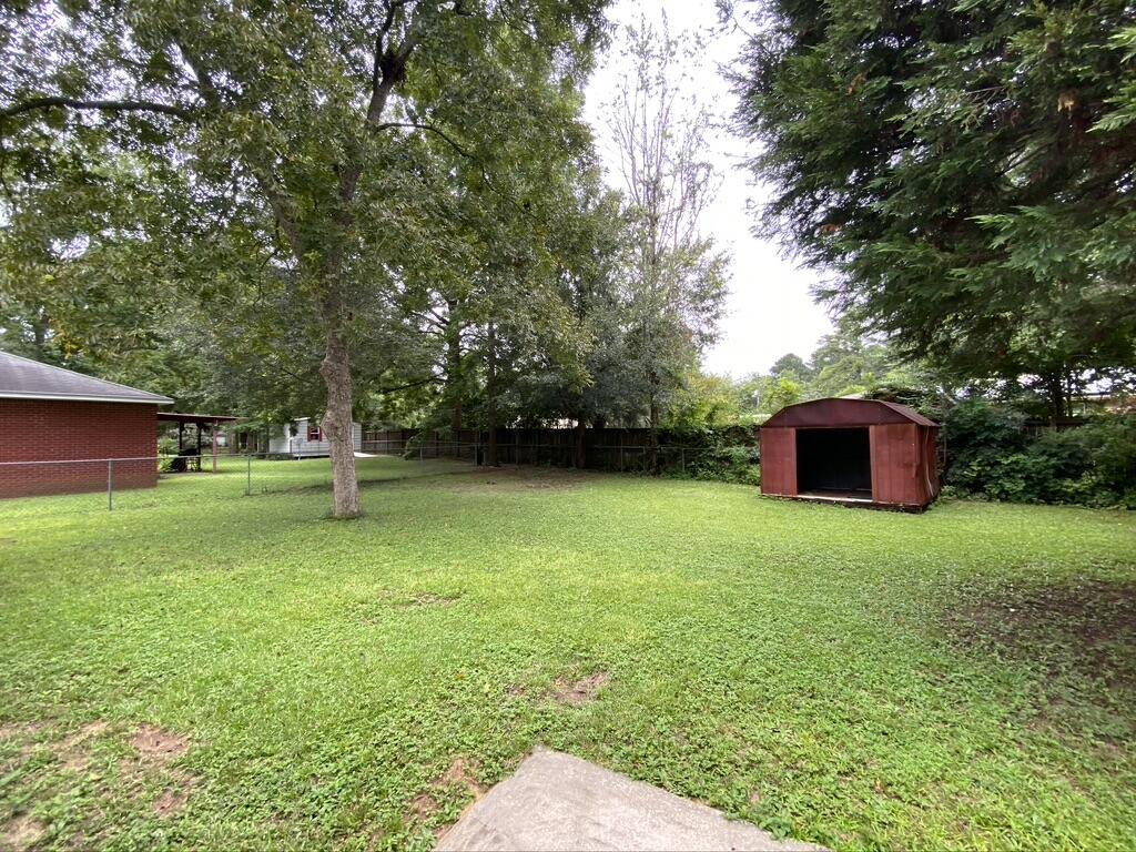 205 Powell Drive Crestview, FL 32536 - Photo 11 of 12 a backyard of a house with lots of green space