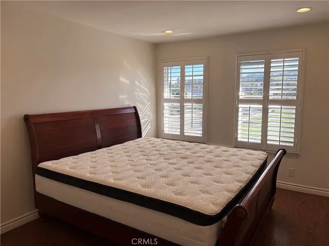 a bedroom with a bed and window