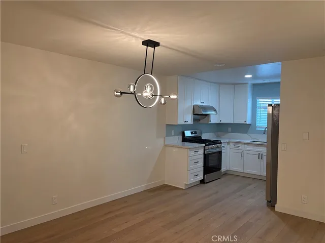 a kitchen with a sink cabinets and stainless steel appliances