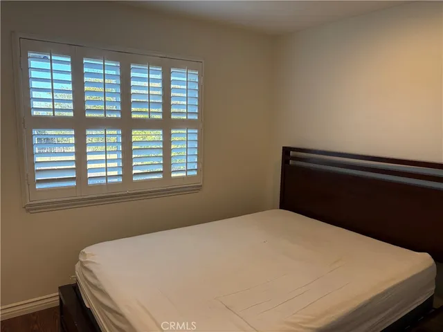 a bed sitting in a bedroom next to a window