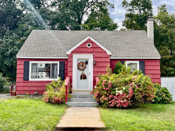 a front view of a house with a garden