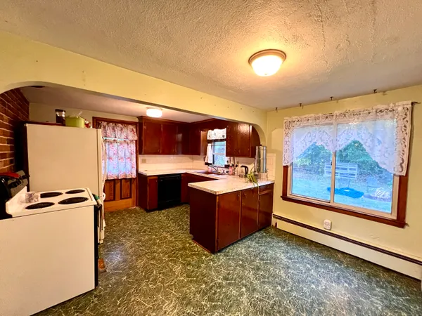 a kitchen with stainless steel appliances granite countertop a sink and a refrigerator