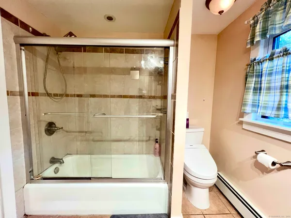 a bathroom with a shower and a toilet