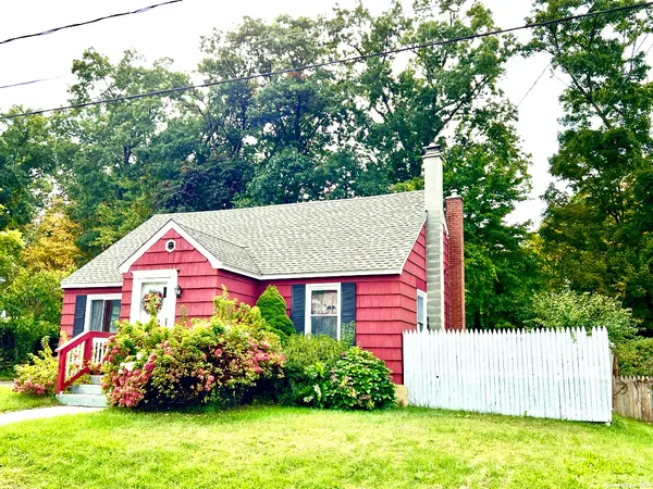 a front view of small house with yard and green space