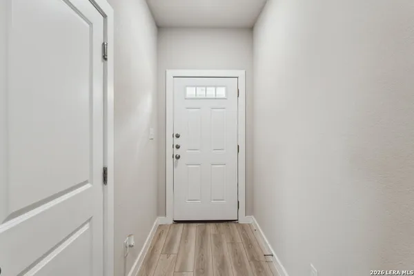 a view of a hallway with wooden floor
