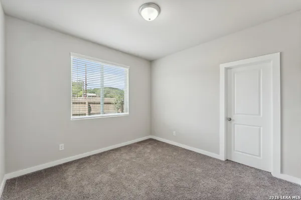 an empty room with windows and closet