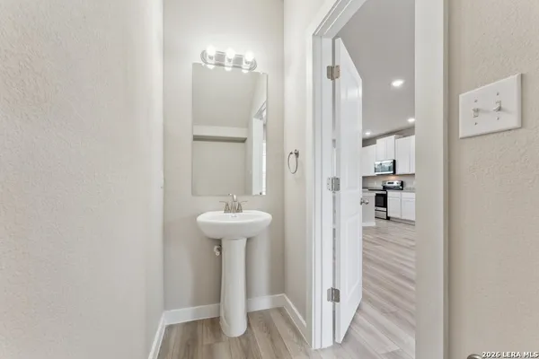 a bathroom with a sink a mirror and shower