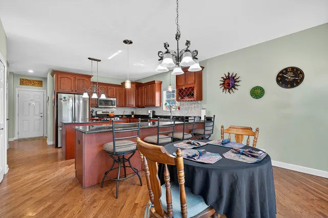 a view of a dining room with furniture and chandelier