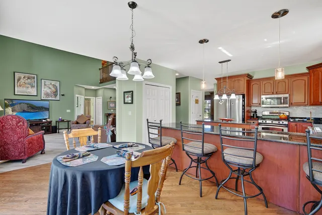 a view of a dining room with furniture and a chandelier