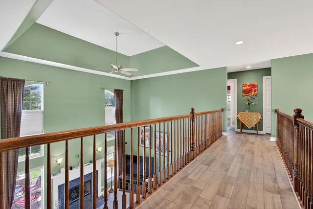 a view of a hallway with a livingroom with furniture and stairs