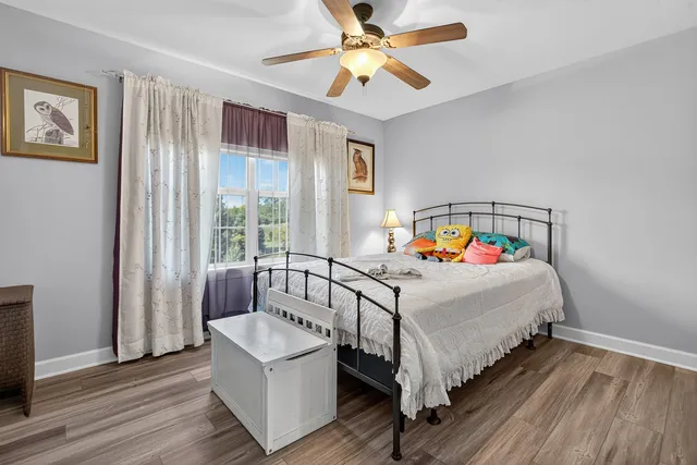 a bedroom with a bed and a large window