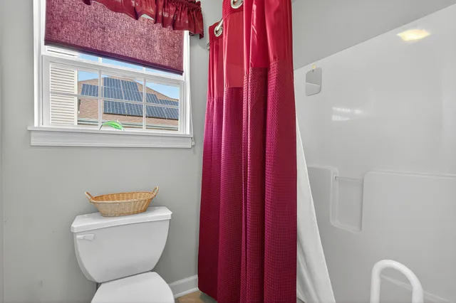 a bathroom with a toilet and a shower