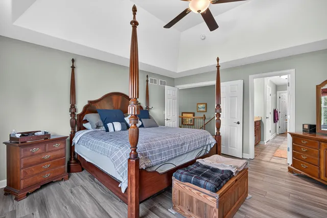a bedroom with a bed and wooden floor