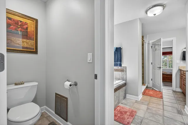 a bathroom with a toilet and a shower