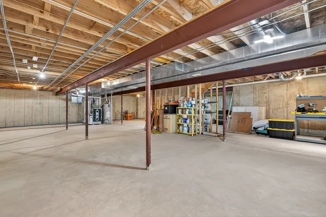 a view of a big room with air conditioner duct and materials on floor