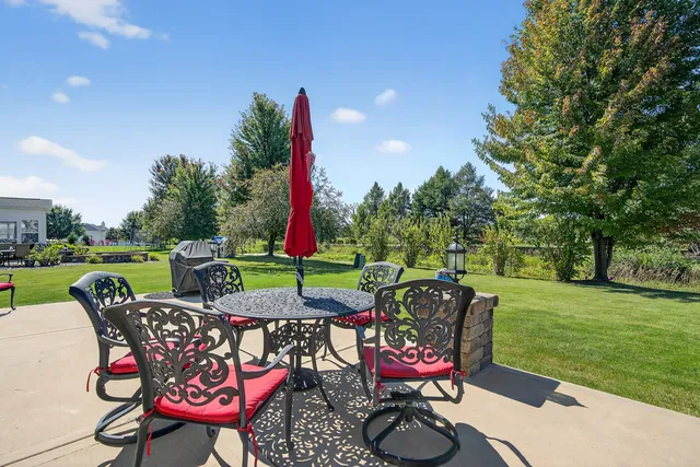 a patio with a table and chairs