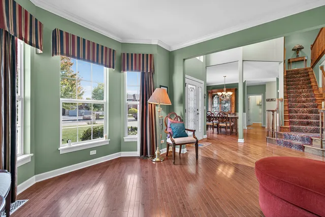 a view of a livingroom with furniture wooden floor and windows