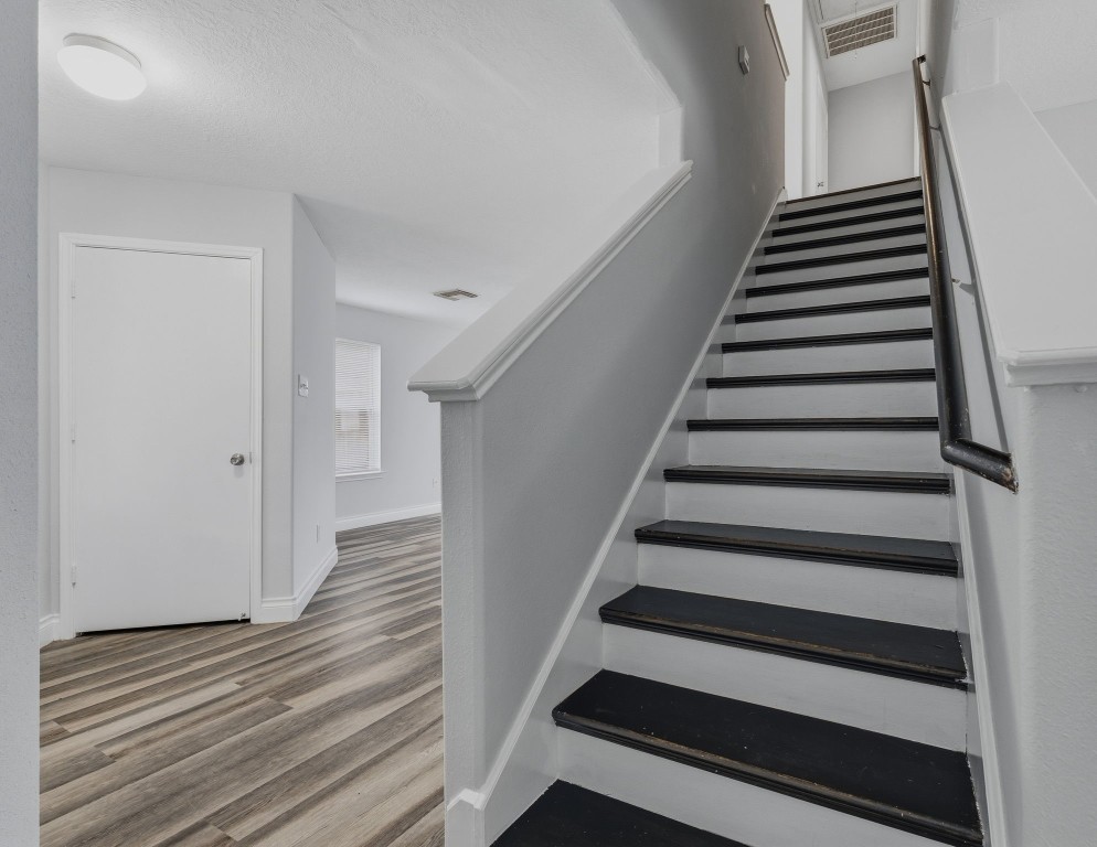 1427 Hade Falls Lane Houston, TX 77073 - Photo 17 of 31 A stained wood staircase adds warmth and character to the interior design, enhancing the home’s overall appeal.