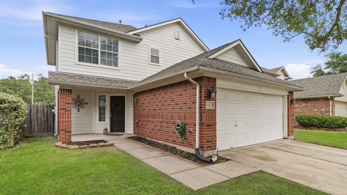 1427 Hade Falls Lane Houston, TX 77073 - Photo 2 of 31 This is a two-story brick and siding house with a two-car garage. It features a well-maintained lawn and a welcoming front entrance.