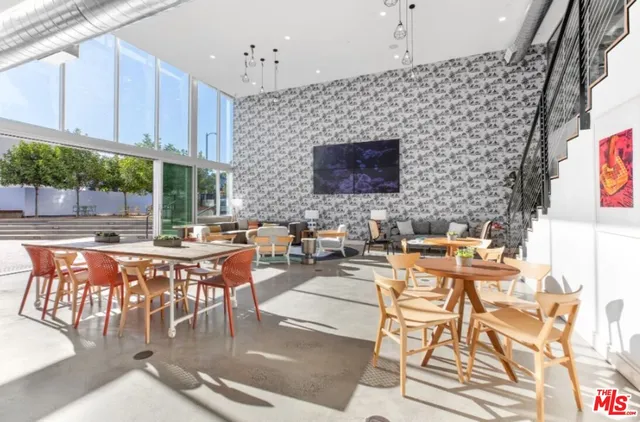 a living room with fireplace a flat screen tv a dining table and chairs