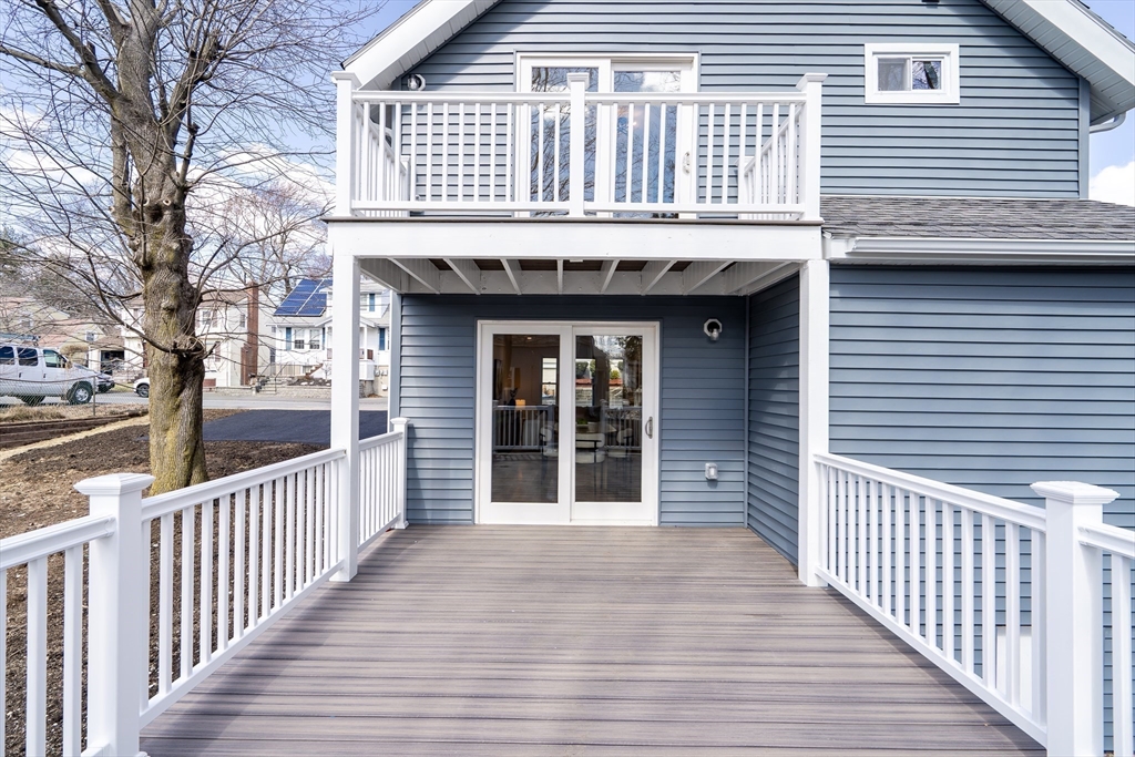 56 Riverview Street Dedham, MA 02026 - Photo 24 of 29 a view of a house on a deck