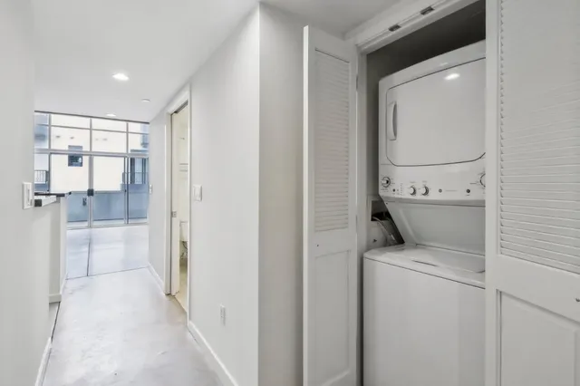 a view of washer and dryer with bathroom