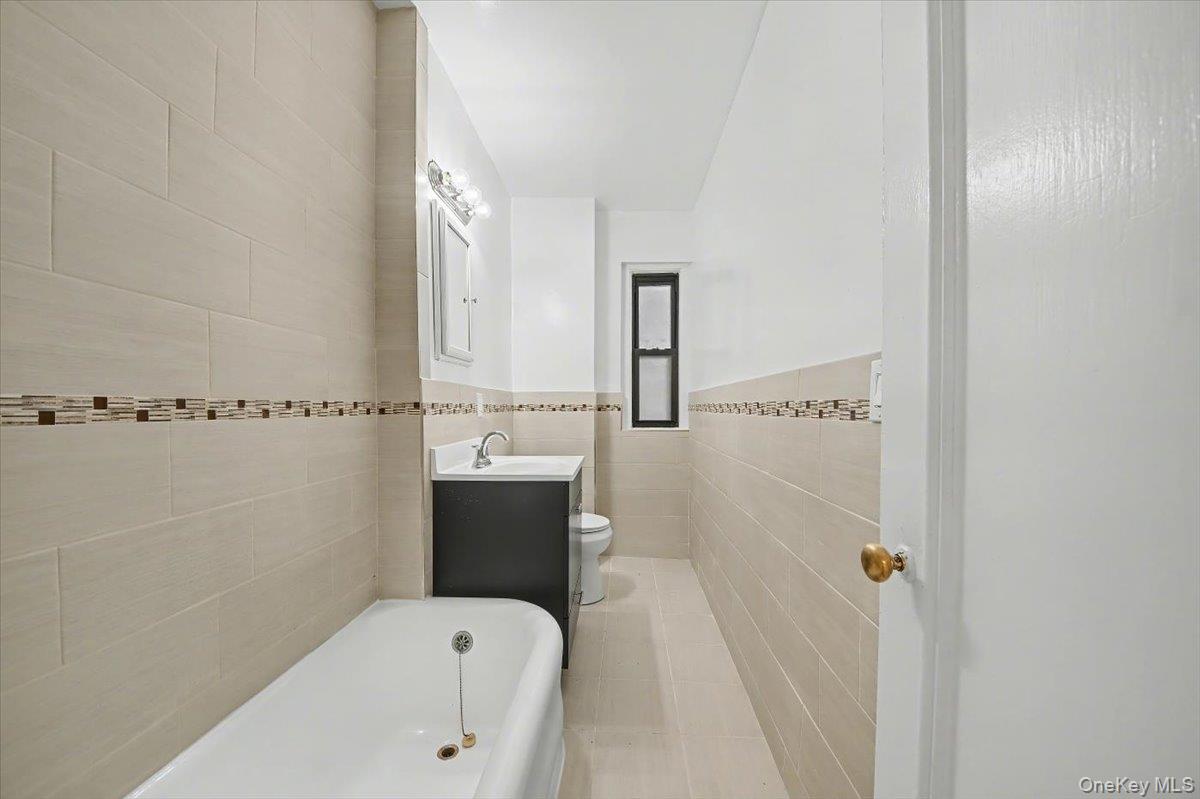 127 Garth Road, Unit 5D Scarsdale, NY 10583 - Photo 16 of 20 a bathroom with a bathtub sink vanity and toilet