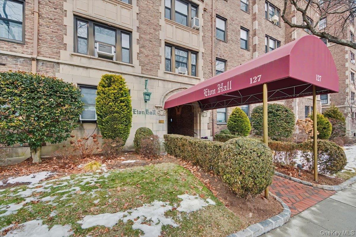 127 Garth Road, Unit 5D Scarsdale, NY 10583 - Photo 2 of 20 a front view of a house with a yard