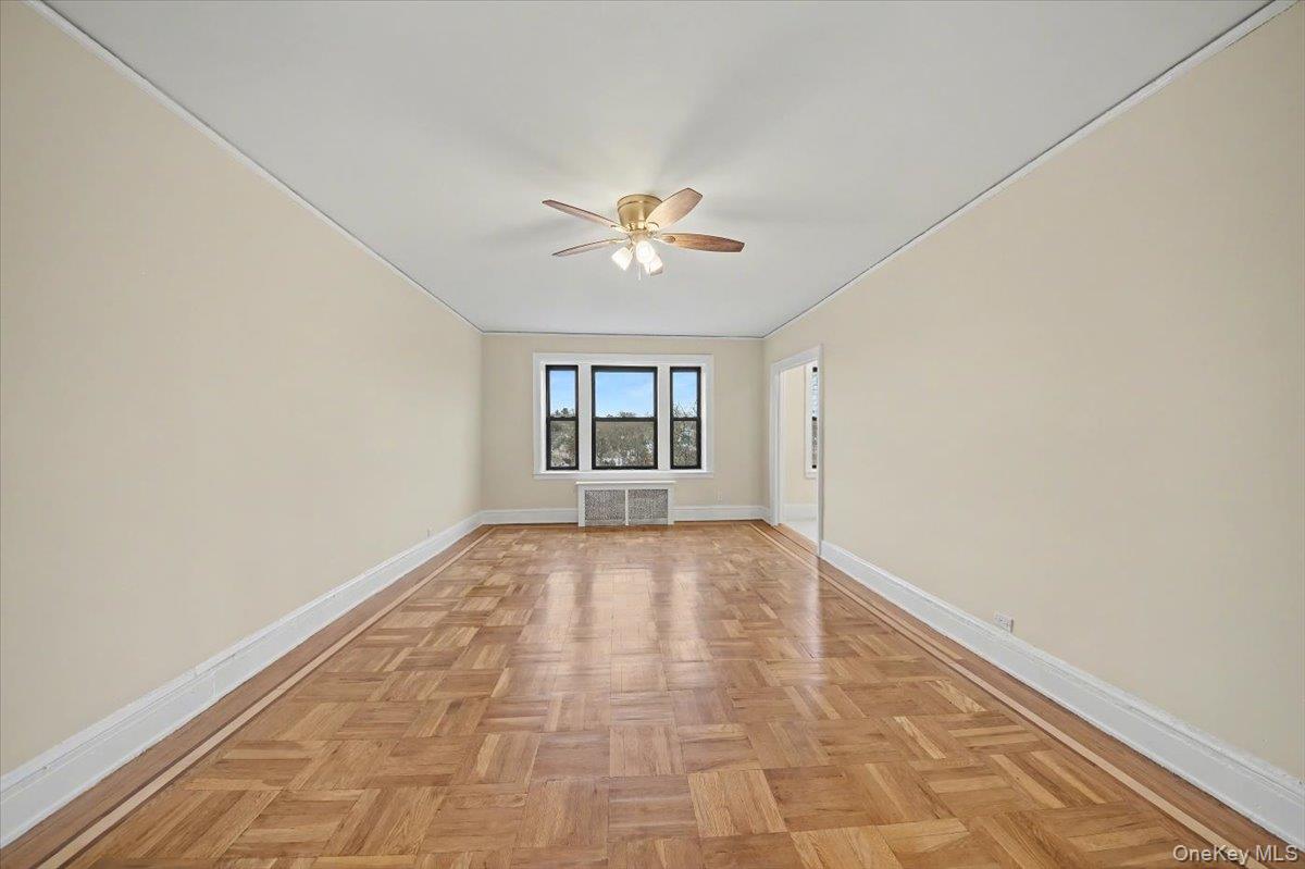 127 Garth Road, Unit 5D Scarsdale, NY 10583 - Photo 3 of 20 wooden floor in an empty room with a window