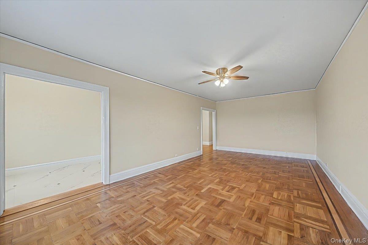 127 Garth Road, Unit 5D Scarsdale, NY 10583 - Photo 4 of 20 a view of a livingroom with a ceiling fan and window