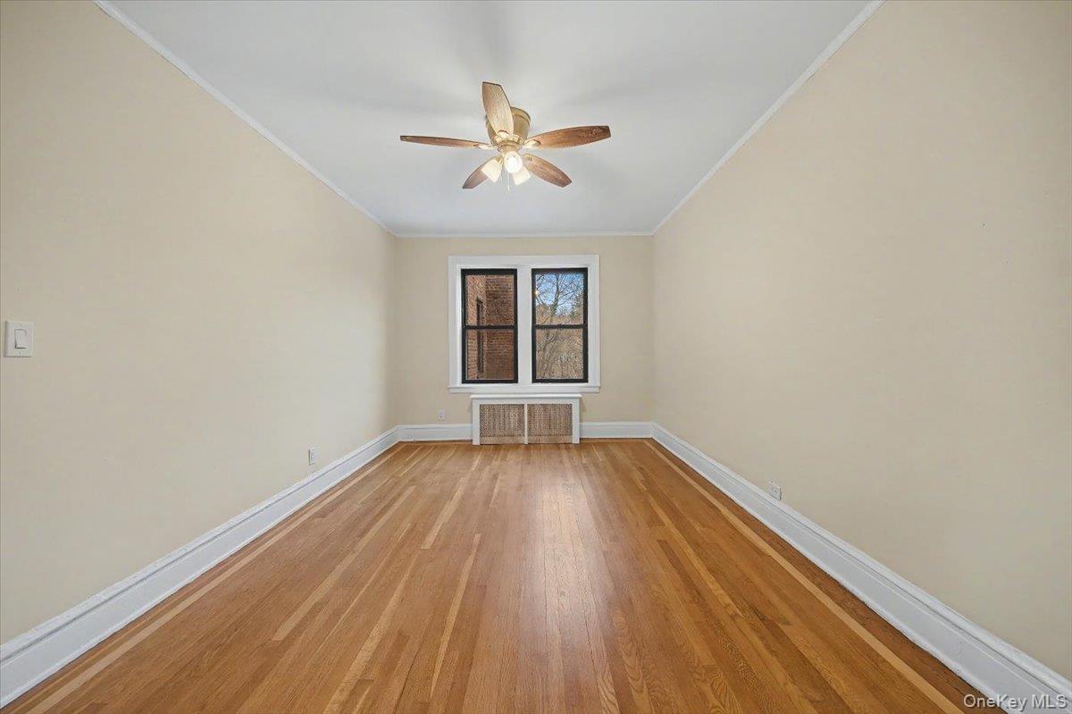 127 Garth Road, Unit 5D Scarsdale, NY 10583 - Photo 5 of 20 wooden floor in an empty room with a window