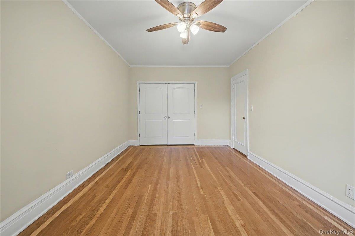 127 Garth Road, Unit 5D Scarsdale, NY 10583 - Photo 6 of 20 a view of an empty room with wooden floor