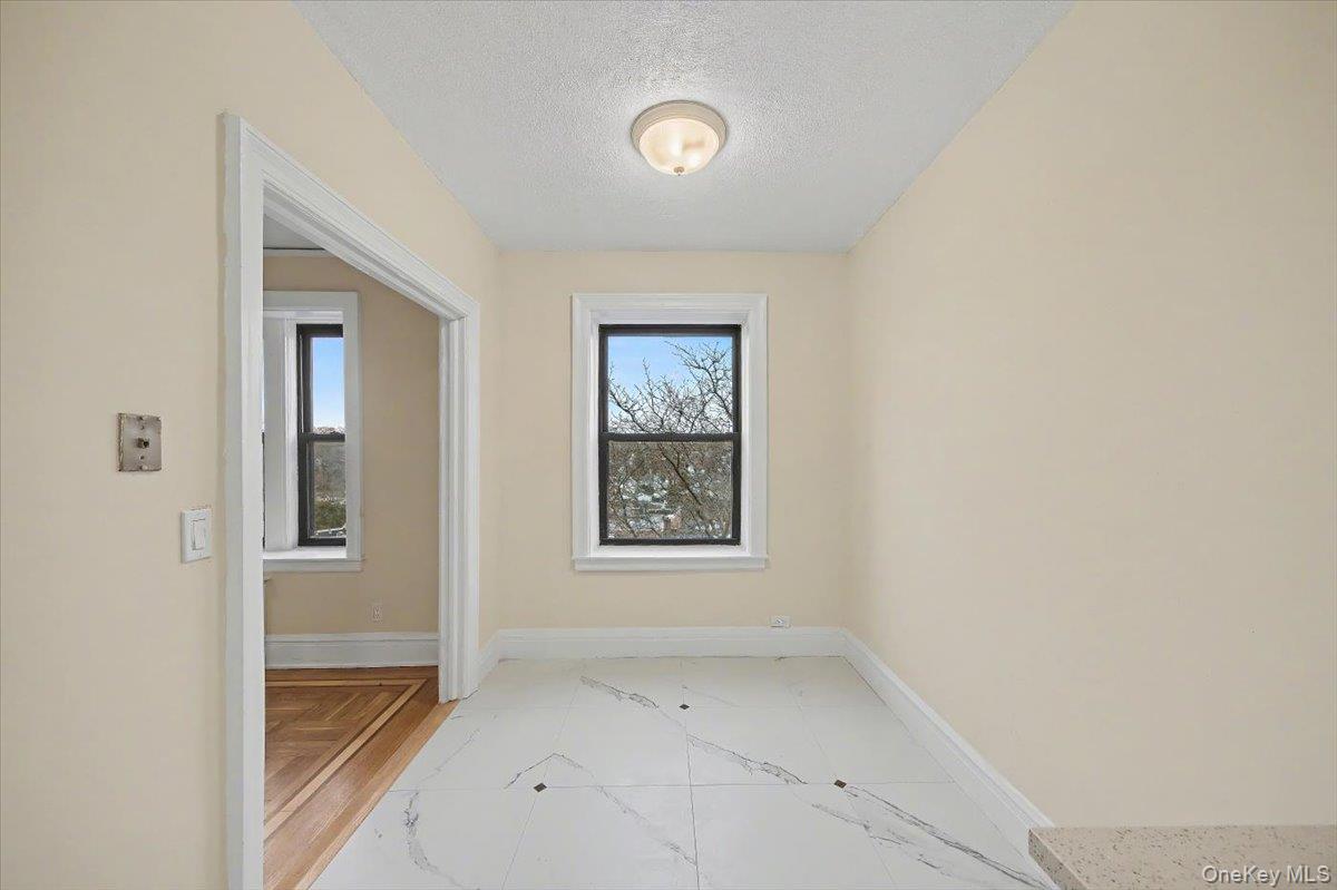 127 Garth Road, Unit 5D Scarsdale, NY 10583 - Photo 10 of 20 a view of an empty room with a window