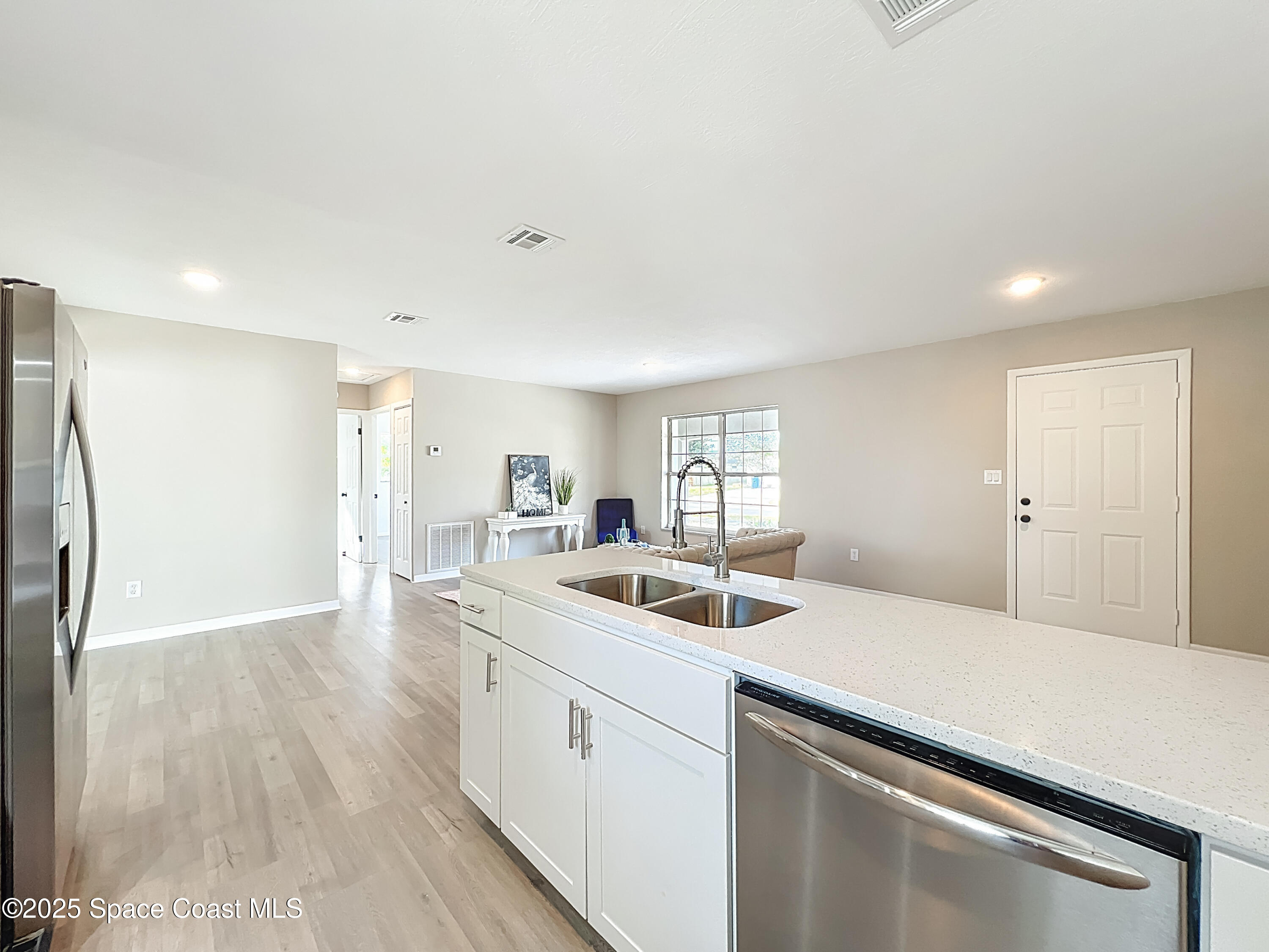 983 Vangi Lane Northeast Palm Bay, FL 32905 - Photo 21 of 35 Kitchen looking over family