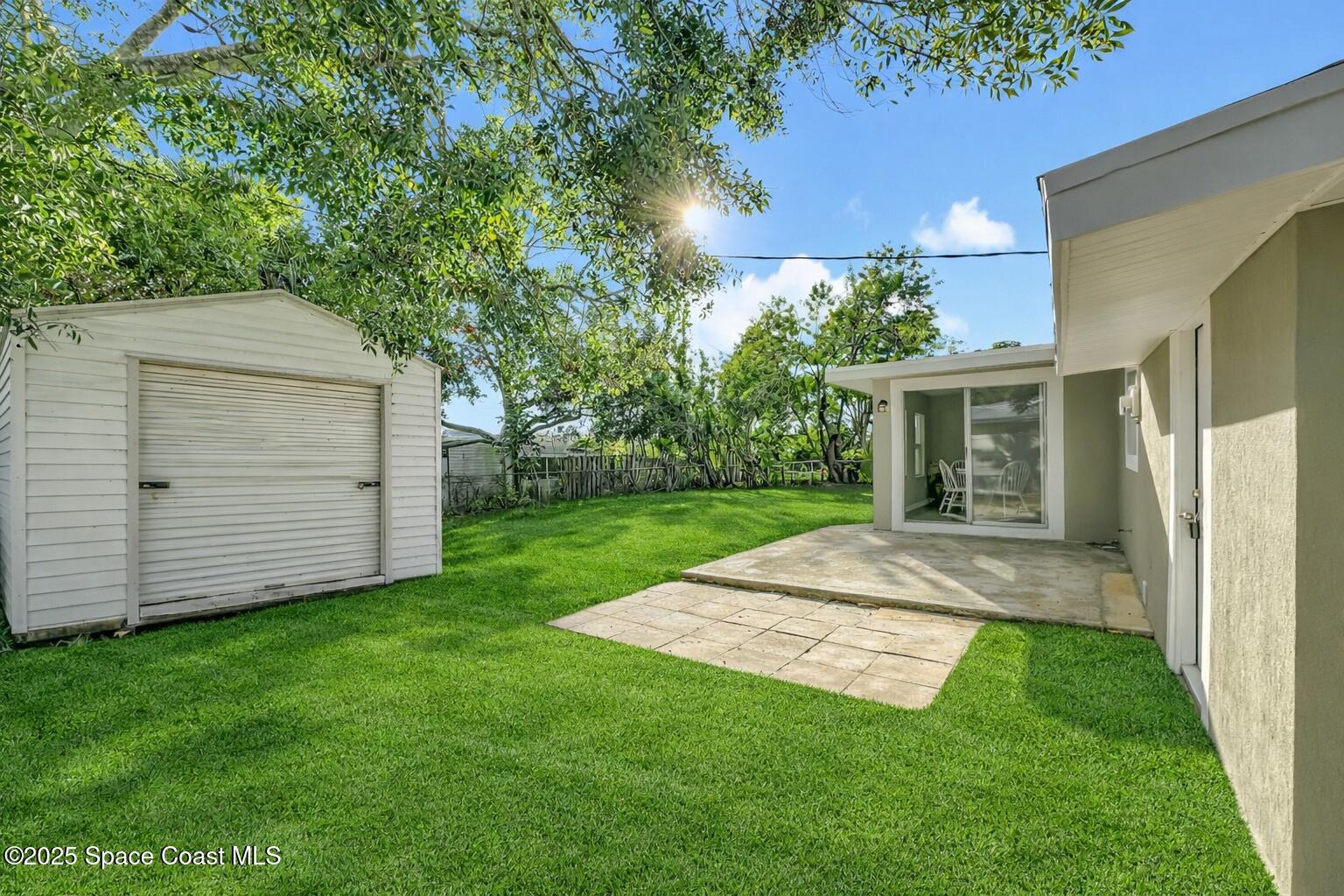 983 Vangi Lane Northeast Palm Bay, FL 32905 - Photo 4 of 35 Backyard with shed