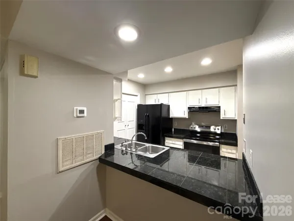 a kitchen with a refrigerator and a stove