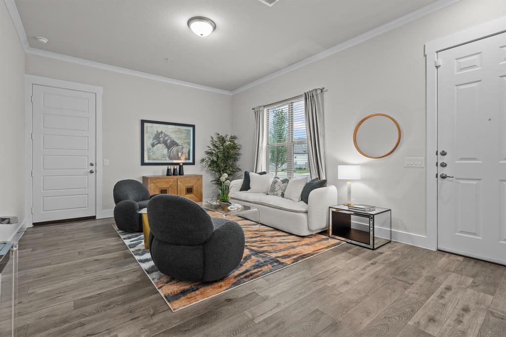 3272 Ganzer Road West, Unit 112B Denton, TX 76207 - Photo 4 of 25 a living room with furniture and a wooden floor