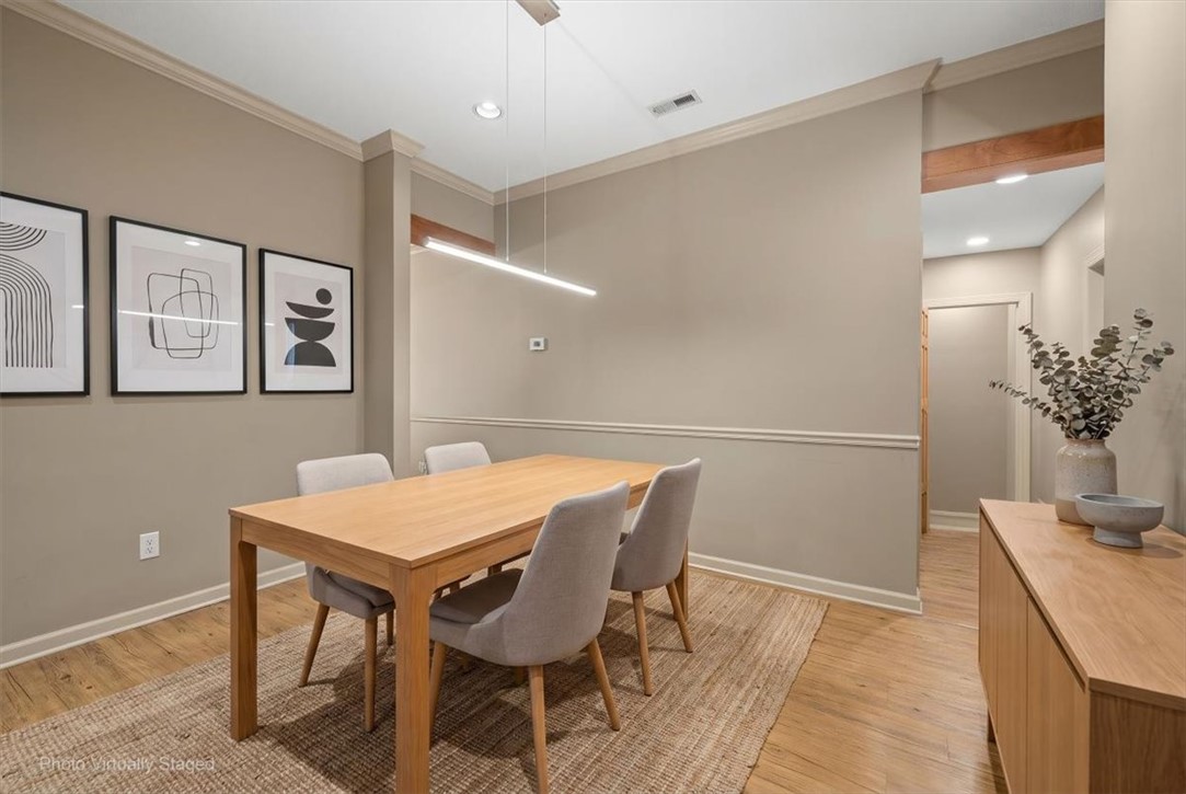 1102 West End Avenue Anderson, SC 29625 - Photo 13 of 28 Hardwood floors and crisp trim details define this inviting dining space.