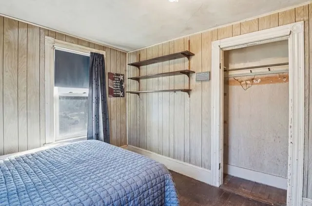 a bedroom with a bed and a mirror